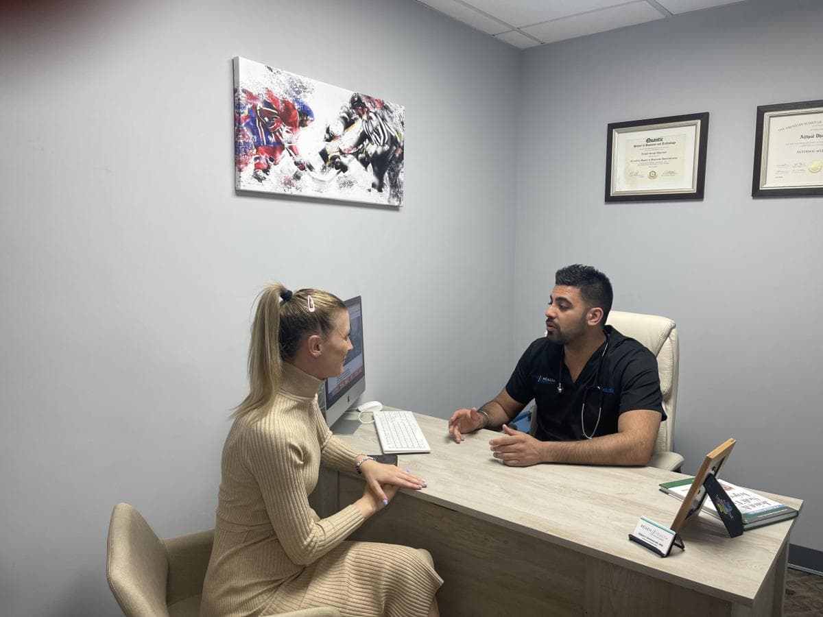 Dr. Dhaliwal in consultation with patient